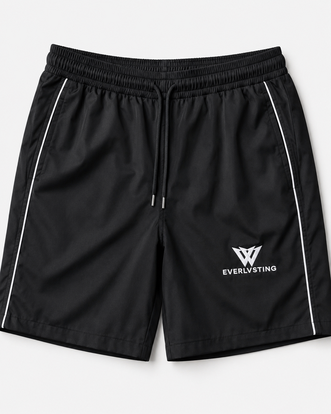EVERLVSTING performance shorts — front view with monogram and reflective piping